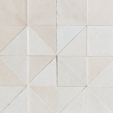 Vintage collage of torn kraft and newsprint paper fragments arranged in a symmetrical geometric pattern for artistic backgrounds and scrapbooking
