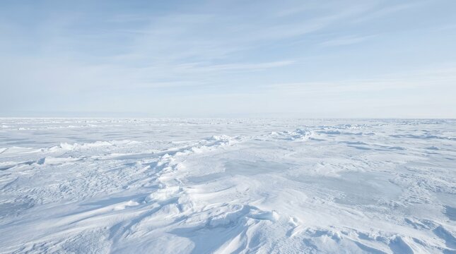 A wide, panoramic view of a vast, icy expanse. The image captures a seemingly endless, frozen landscape, likely a polar region.