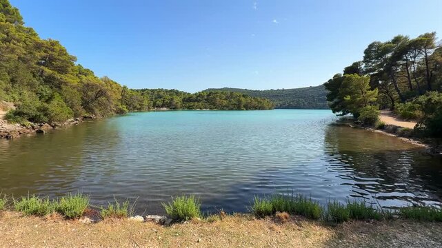 View of Malo Jezero or Small Lake in Mljet National Park on Mljet Island in Croatia. Protected Mediterranean nature and peaceful lake landscape concept.