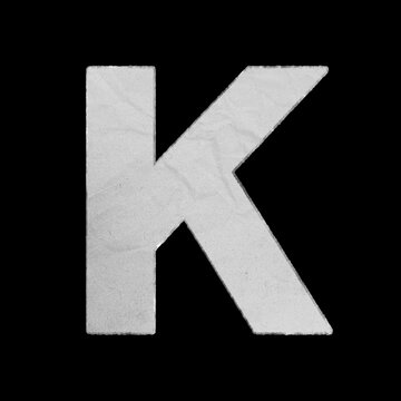 Capital letter K made of textured white paper isolated on black background