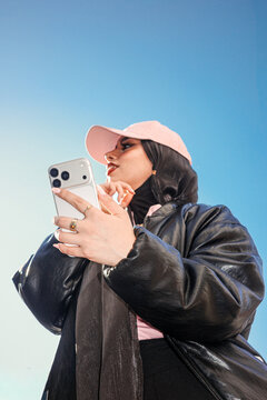 Holding Smartphone Under Clear Blue Sky