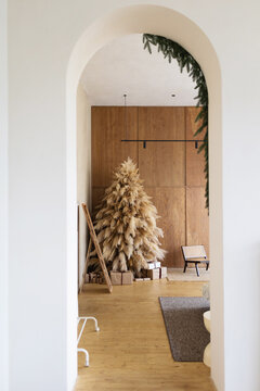 Mockup of modern interior with Christmas tree seen through the arch