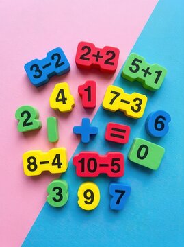 Colorful Foam Numbers and Mathematical Equations for Kids Education on Pink and Blue Background - Early Learning Concept