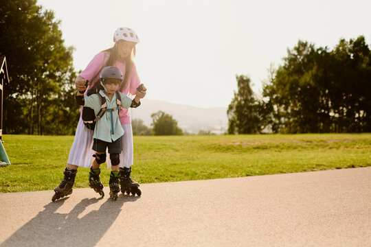 Mother Supporting Child on Roller Skates