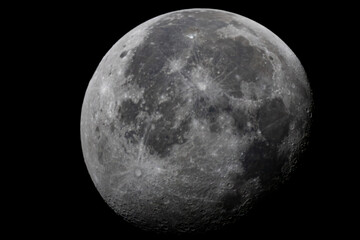 The illuminated surface of the moon with visible lunar maria floating in deep space. © Grey Zone