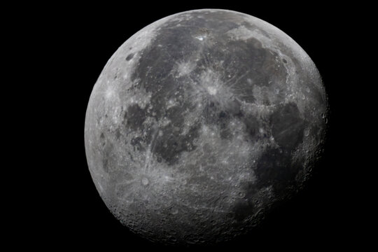 The illuminated surface of the moon with visible lunar maria floating in deep space.