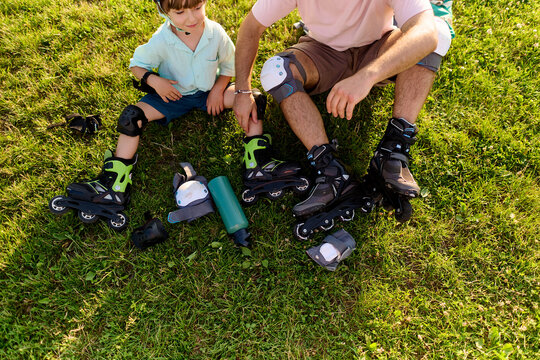 Father and Son Taking a Roller Skating Break