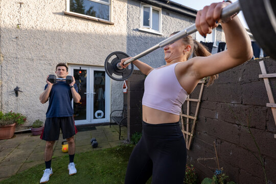 Couple working out together in their backyard at sunset