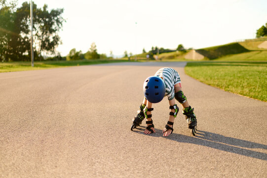 Little boy getting up after a roller skating fall