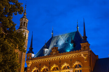 Artus Court facade and roof decorated with light at night, Torun, Poland © marcinsl1987