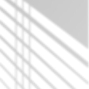 Abstract light and shadow pattern created by window blinds on a white wall