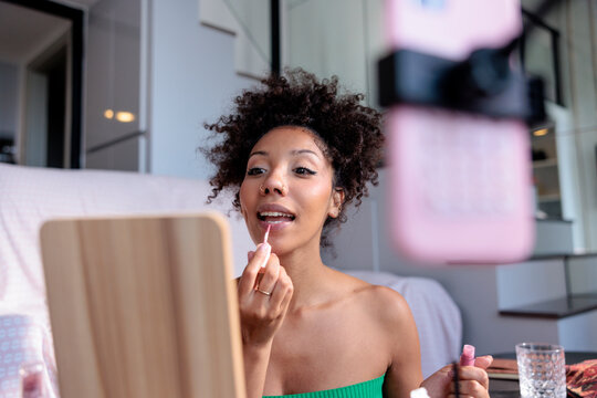Beauty influencer recording a makeup tutorial for social media