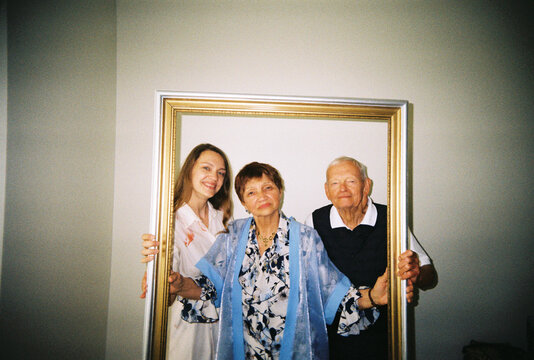 Parents Poses With Adult Daughter for a Funny Photo