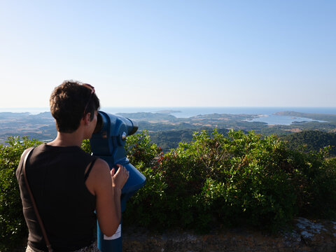 Woman viewing panoramic landscape from Monte Toro, Menorca