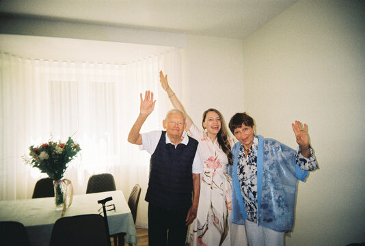 Parents Poses With Adult Daughter for a Funny Photo At Home