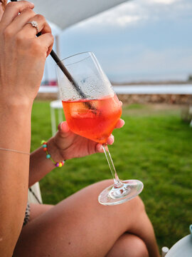 Woman enjoying refreshing cocktail on summer vacation in Menorca