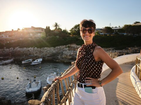 Woman enjoying Mediterranean sunset view in Menorca