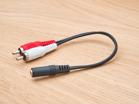 RCA to 3.5mm Jack Audio Adapter Cable - Close-up view of an RCA stereo audio Y-adapter cable with red and white male plugs connecting to a black female 3.5mm jack.