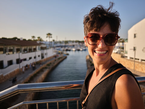 Woman smiling enjoying summer vacation in Menorca, Spain