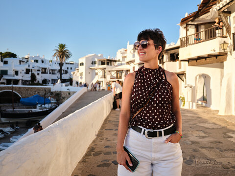 Woman enjoying vacation in white village street