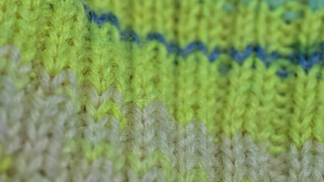 A close-up of a vibrant knitted blanket with intricate patterns