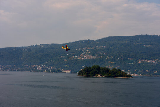 Firefighter Plane Flies Over Lake and Island on a Cloudy Day