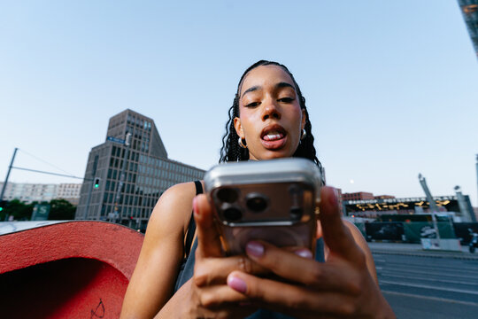 Young Woman Using Smartphone Outdoors