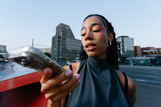 Young Woman Using Smartphone Outdoors