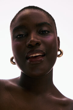 Portrait of a Person Smiling With Short Hair and Large Earrings