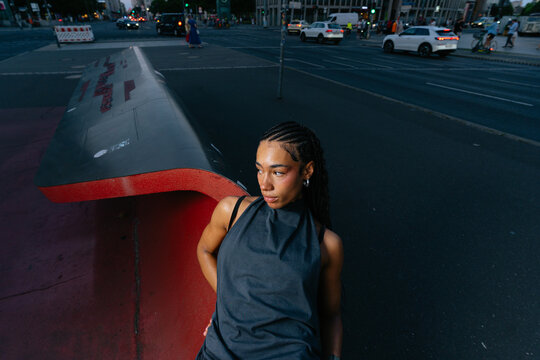 Woman Leaning Against Urban Structure