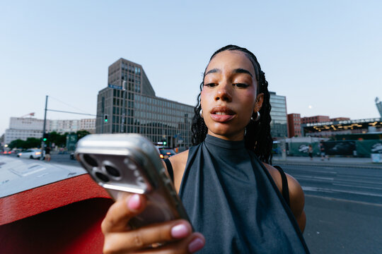 Young Woman Using Phone in Berlin
