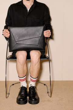 Stylish Black Leather Briefcase Held While Sitting