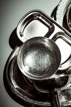 Metal Bowls and Containers Stacked Together on a Flat Surface