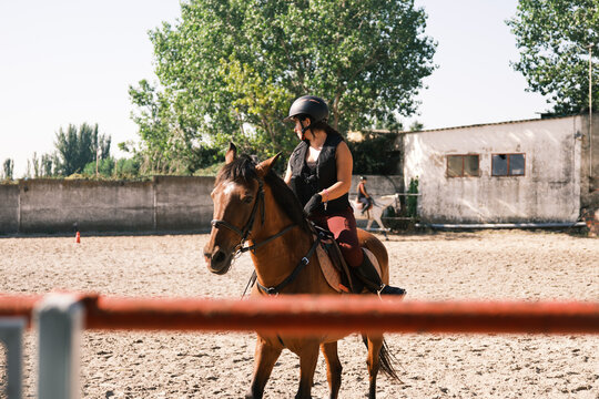 Cheerful horsewoman riding outdoors