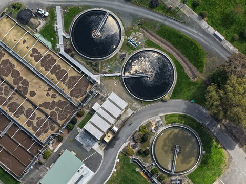 Lilydale, Victoria, Australia - 10 September 2026: Aerial view of the Lilydale Wastewater Treatment Plant with circular sedimentation tanks and rectangular aeration basins.