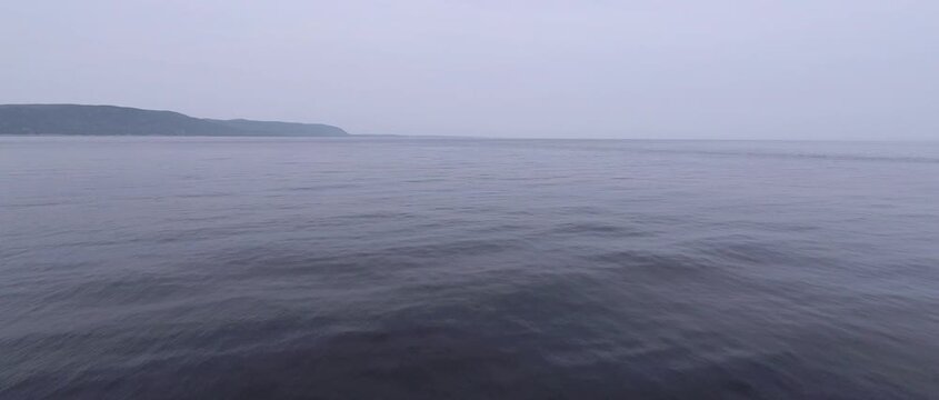 Calm St. Lawrence estuary with distant headland