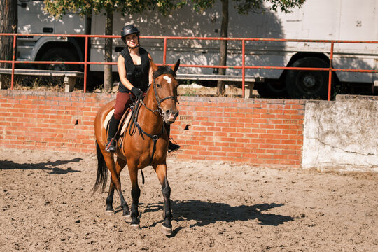 Happy horsewoman riding outdoors