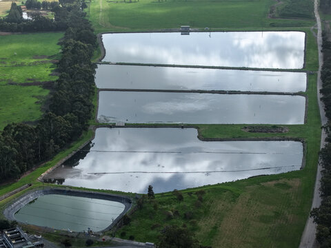 Lilydale, Victoria, Australia - 10 September 2026: Aerial view of the Lilydale Wastewater Treatment Plant featuring several large rectangular settling ponds surrounded by green fields and trees.