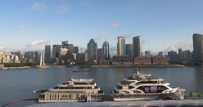 SHANGHAI, CHINA - AUGUST 23, 2026: Sunlight illuminates docked cruise ships and the North Bund skyline along the Huangpu River in SHANGHAI, China, in timelapse