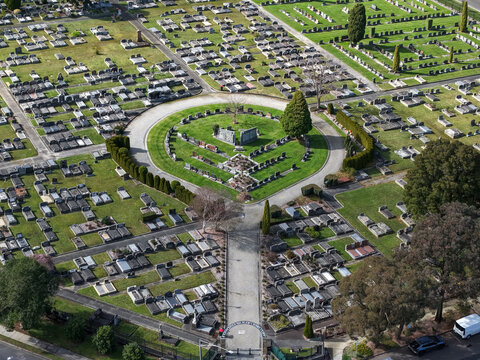 Ferntree Gully, Australia - 09 September 2026: Aerial view of Ferntree Gully Cemetery with its circular layout, rows of gravestones, manicured lawns, and surrounding trees.