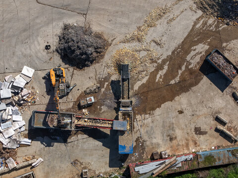 Wantirna South, Victoria, Australia - 08 September 2026: Aerial view of Knox Transfer Station featuring industrial machinery, conveyor belts, and piles of sorted waste materials on a concrete yard.