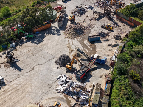 Wantirna South, Australia - 08 September 2026: Aerial view of Knox Transfer Station with excavators and piles of sorted waste materials at an industrial recycling facility.
