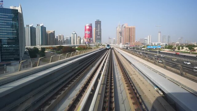 DUBAI, UAE - AUGUST 29, 2026: Dubai Metro train passes in slow motion beside Al Zahra Hospital, a healthcare provider, on elevated tracks in Dubai UAE during daytime