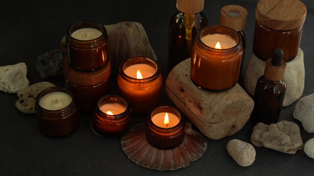 Candles in jars burning. Candle light in glass. Candlelight in night darkness