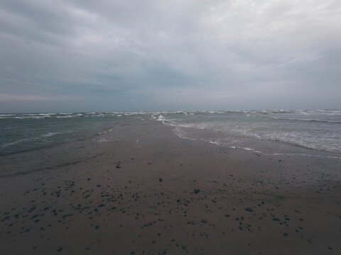 Waves crashing from two opposing sides where North Sea and Baltic Sea meet at Grenen sandbar near Skagen, Denmark
