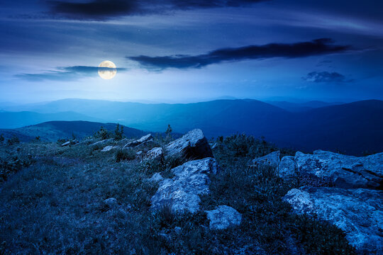 Carpathian mountain landscape in summer at night. scenic view of Transcarpathia region from the mnt. Smooth. alpine blueberry field with rock on the Polonyna Runa hill in full moon light