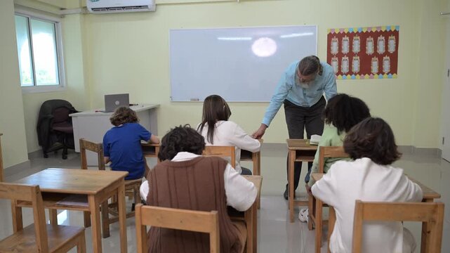 Teacher supporting students during lesson