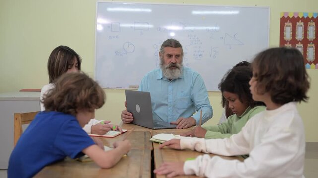 Teacher assisting students with classroom assignment