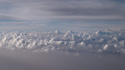 Minimalist horizontal cloudscape featuring gentle cloud textures and an open blue sky, suitable for inspirational banners, wellness themes, and atmospheric wallpapers. © UP