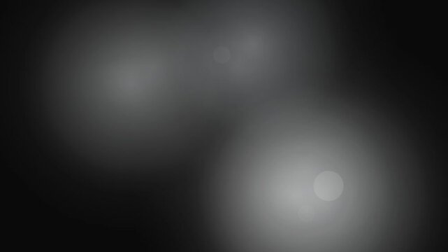 Soft abstract circles create a blurred monochromatic gradient background for design use